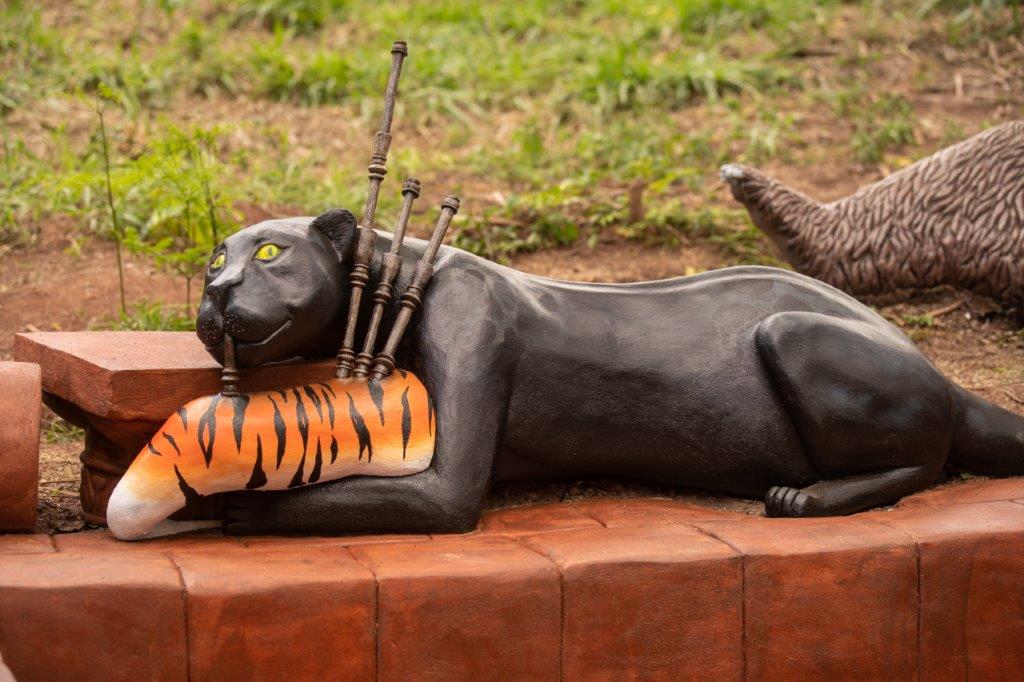 It's Bagheera playing bag pipes made from the defeated Shere Khan!