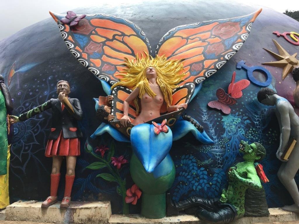 This scene shows a woman emerging from a flower as a butterfly, symbolizing a girl's sexual awakening. A Peeping Tom is shyly watching her from behind a leaf and another teenager is discovering  animalistic sexuality, masturbating while a wolf's head is tearing out of his face