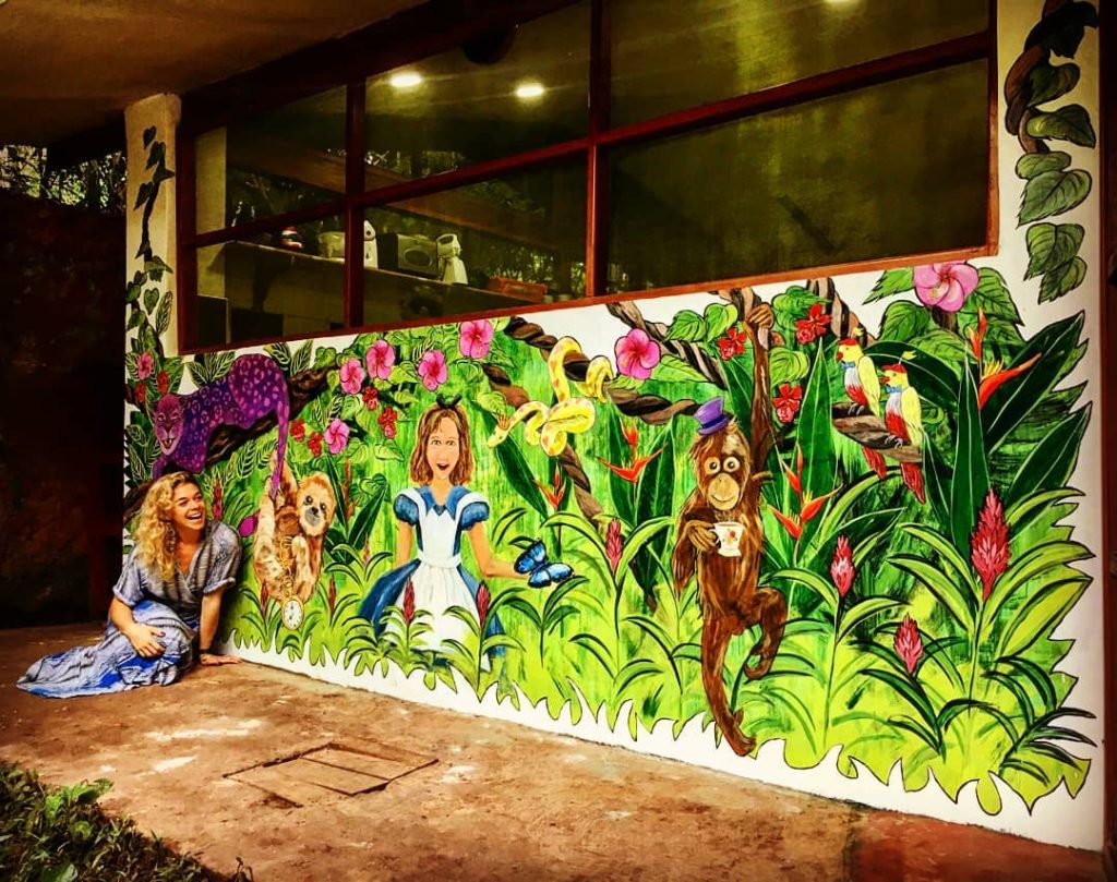 Eli in Wonderland, an Alice in Wonderland mural on the wall of Casablanca, our main dining hall
