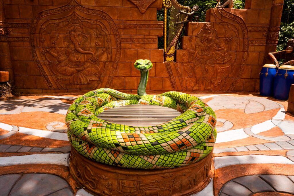 Kaa, the evil python, encircles the fire pit with bbq grill