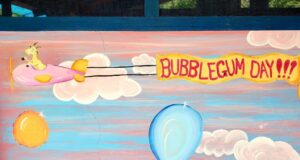 A happy goat flying with a Bubblegum Day banner, everything goes!
